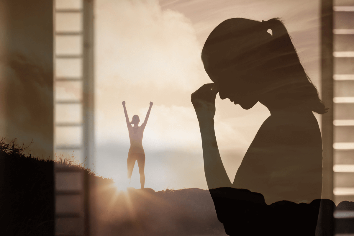 Silhouette of women holding her head in her hands in front of an open window, while the same figure appears in the background, arms raised representing she has overcome anxiety.